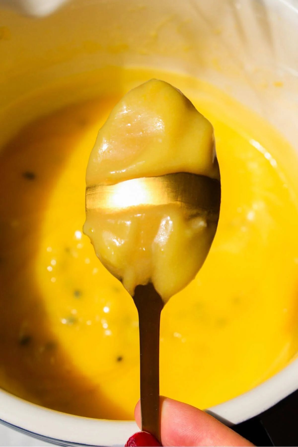 Lemon passionfruit curd on the back of a small spoon.