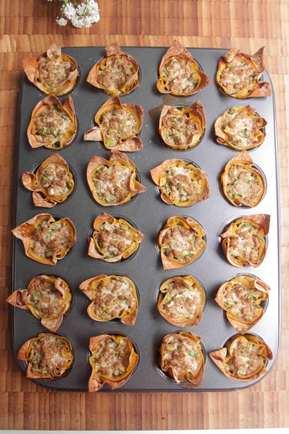 Baked dumpling cups in a mini muffin tin.