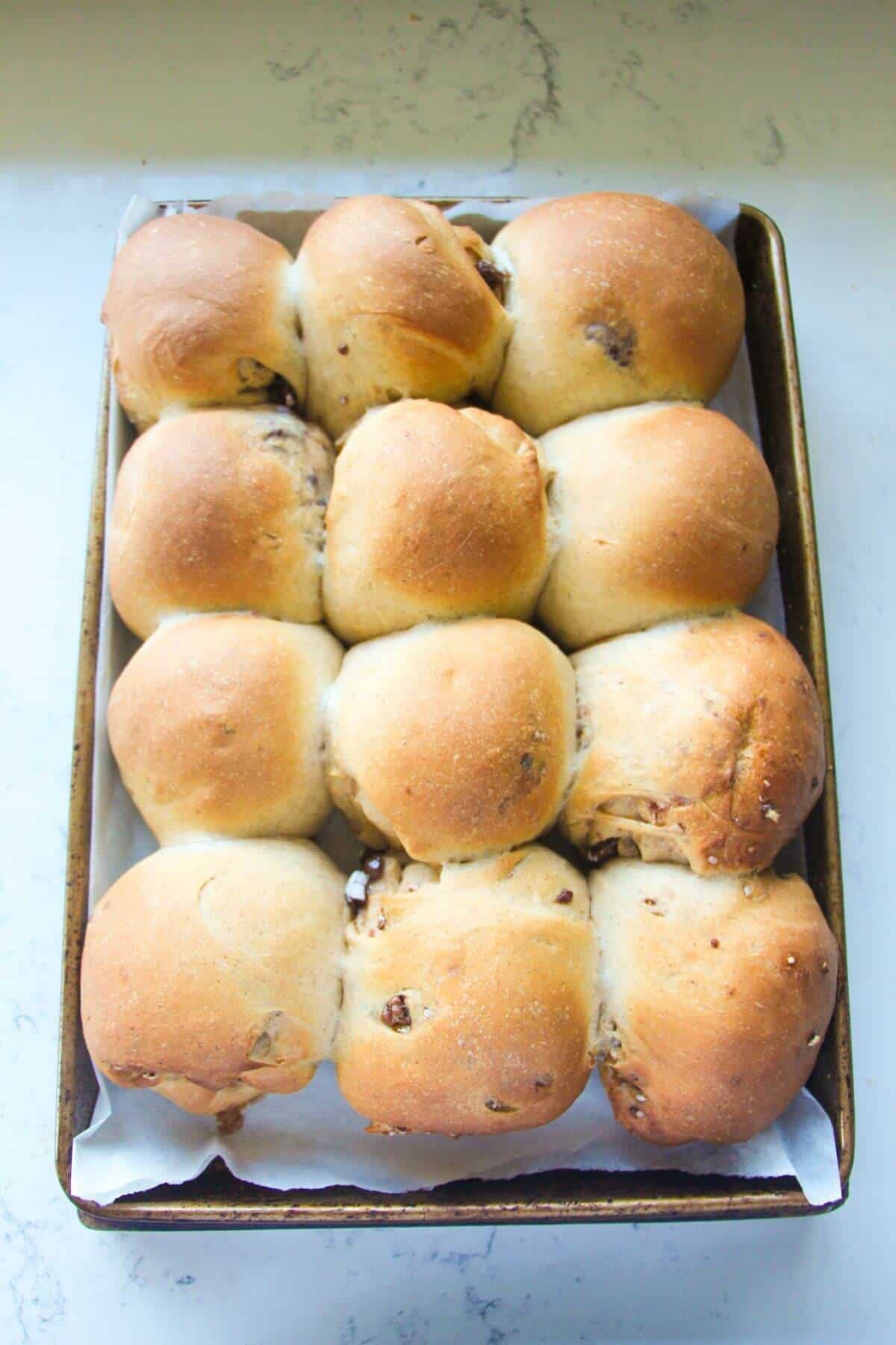 12 mini egg hot cross buns, par-baked in a lined oven tray.
