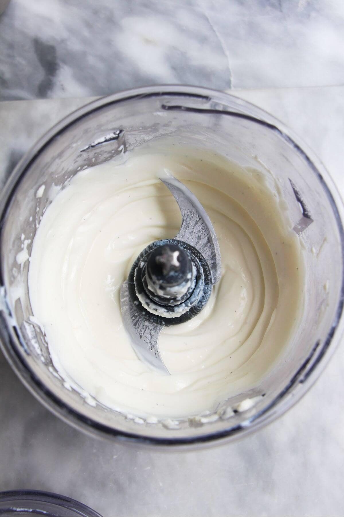 Whipped cream cheese and Greek yogurt in a small food chopper.