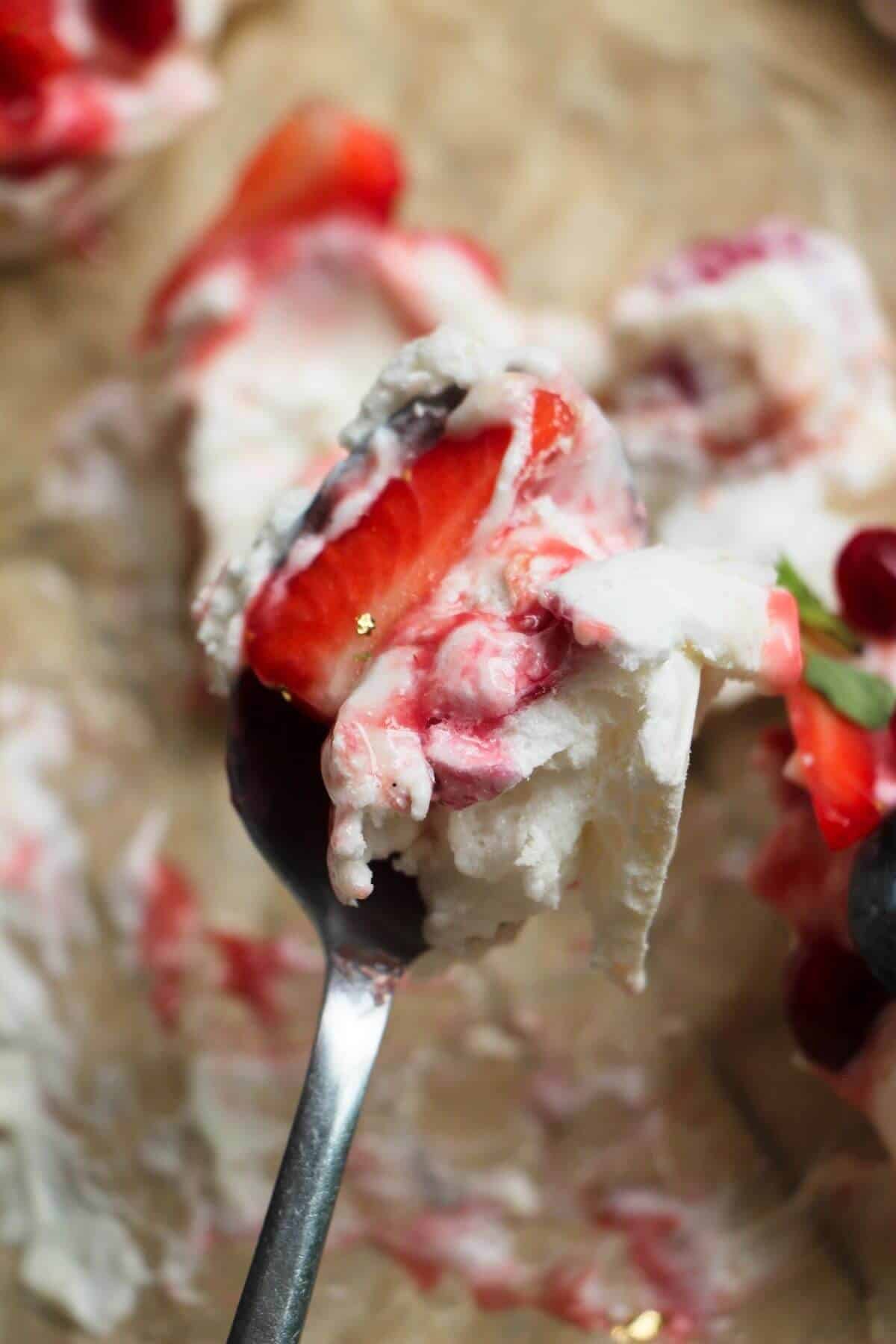 Fluffy pavlova on a small spoon.