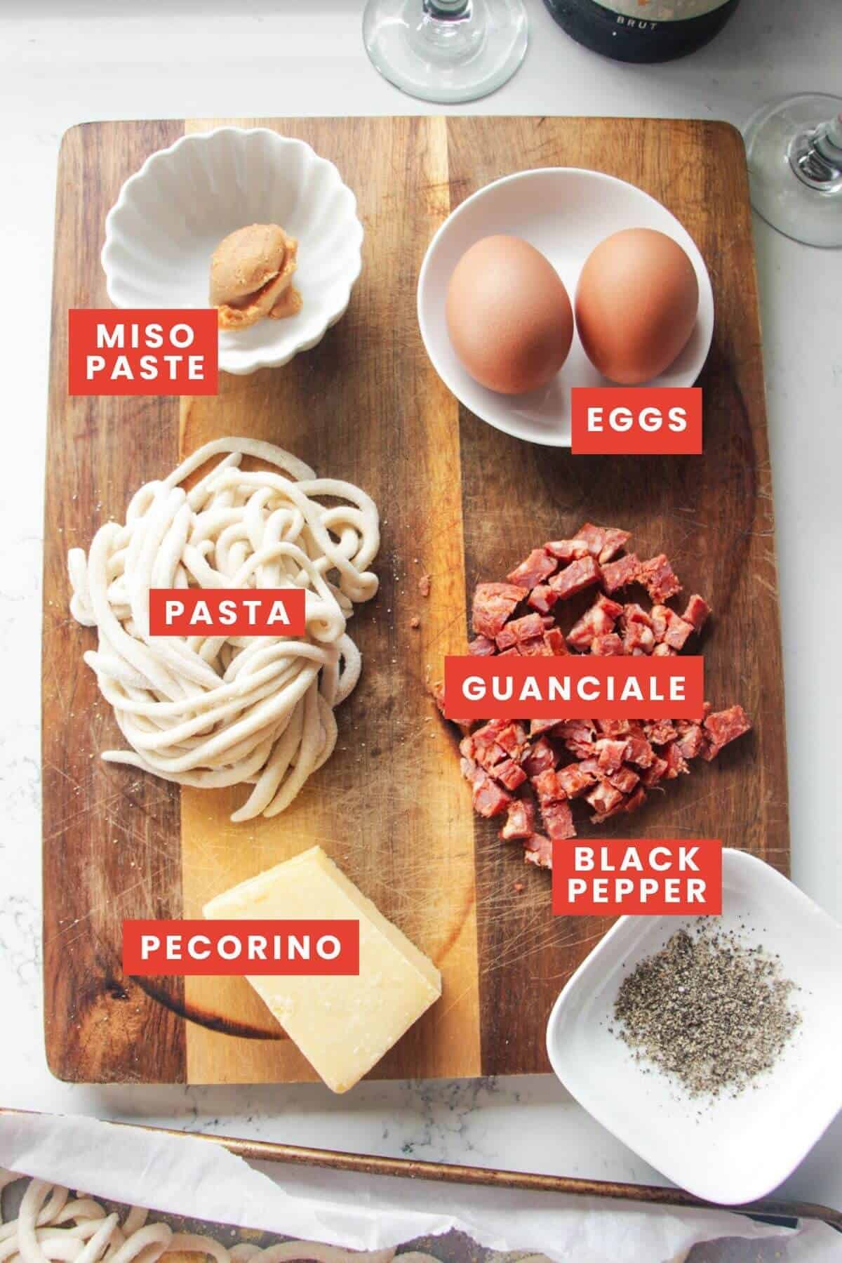 Carbonara ingredients laid out and labelled.