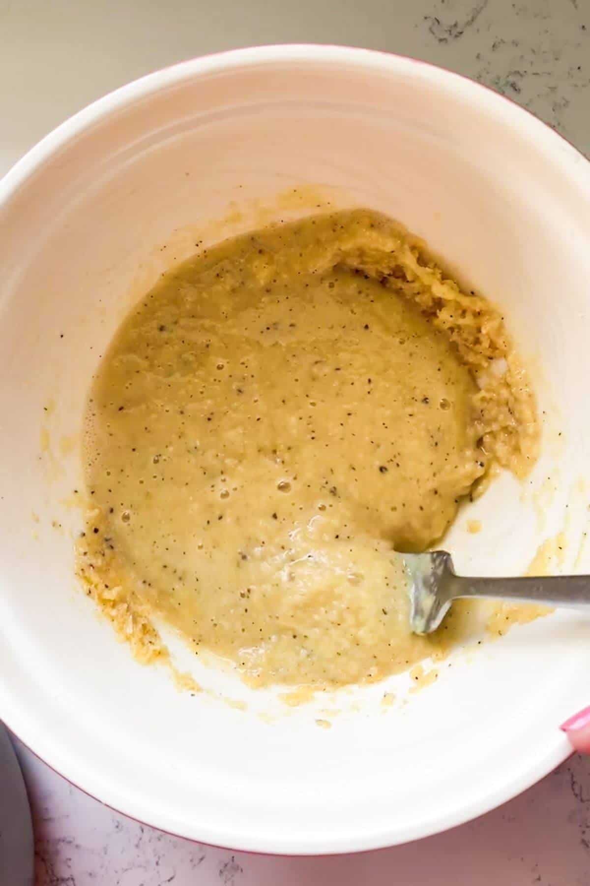 Tempered cheese and egg mix in a mixing bowl.