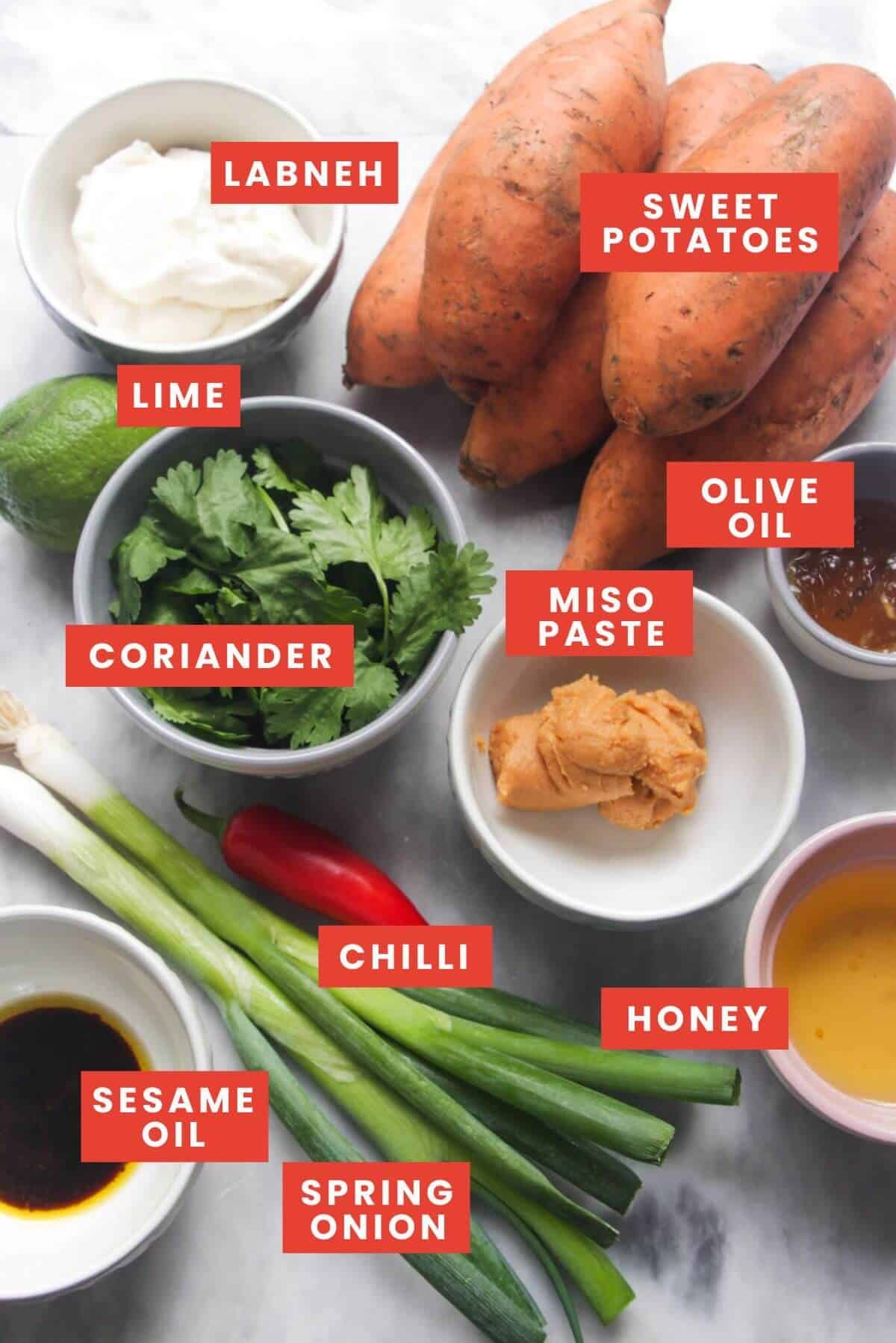 Ingredients for miso roasted sweet potatoes laid out on a grey background and labelled.