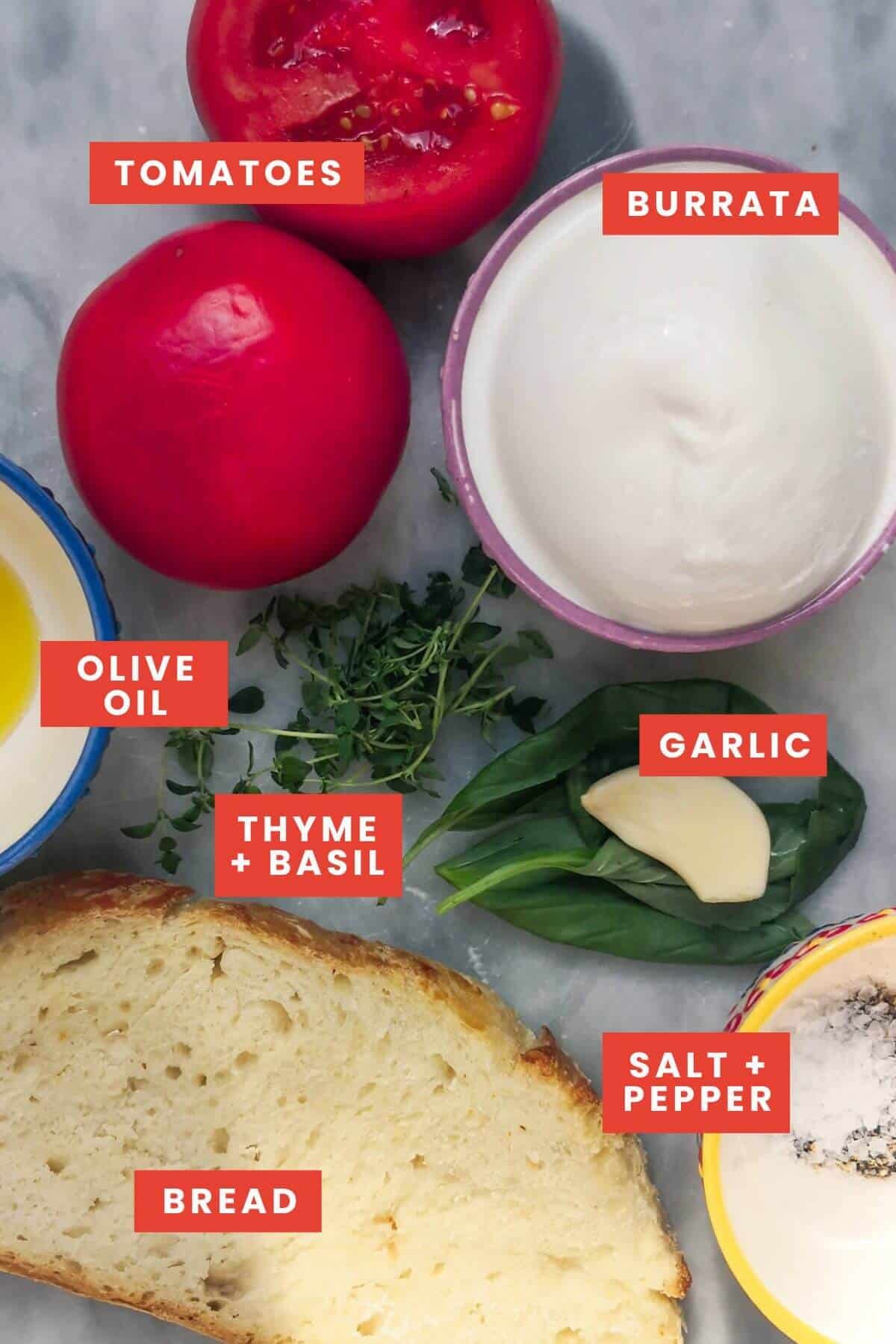 Ingredients for pan con tomate with burrata on a marble surface.
