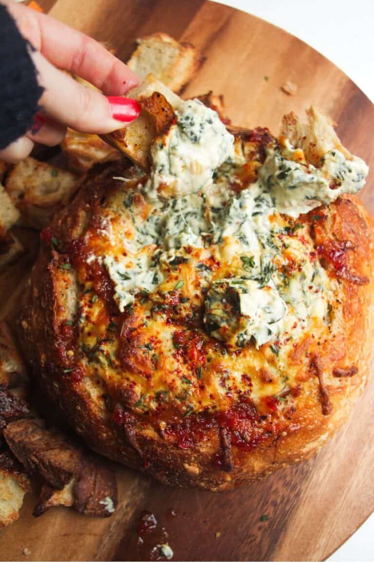 Cheesy spinach dip in a bread bowl.