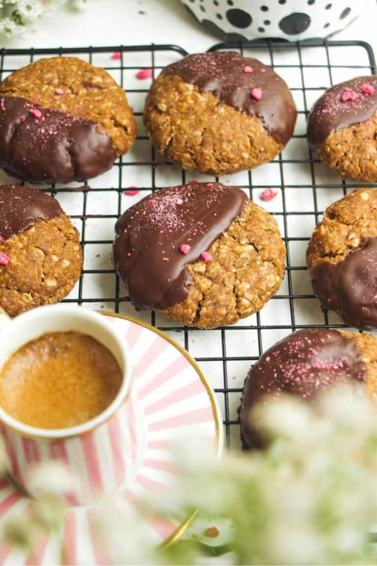 Chocolate dipped Anzac biscuits with coffee on the side.