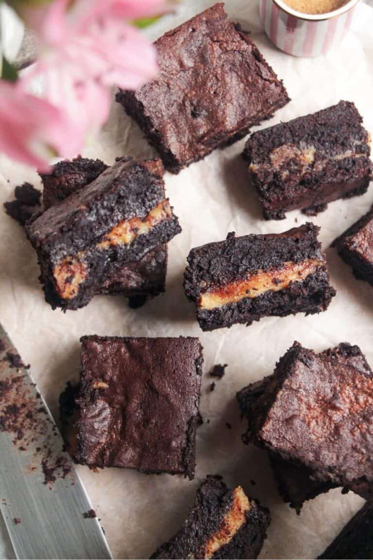 Sliced salted caramel brownies on baking paper.