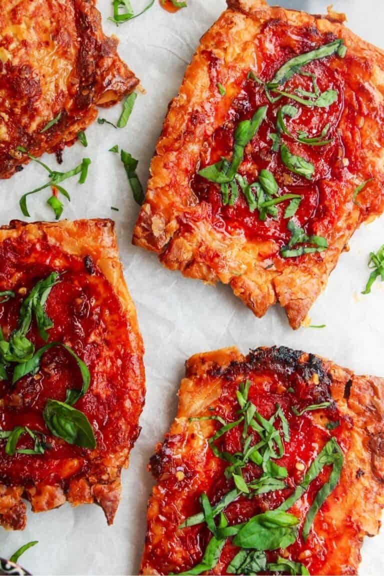 Close up of 3 upside down puff pastry pizza tarts.