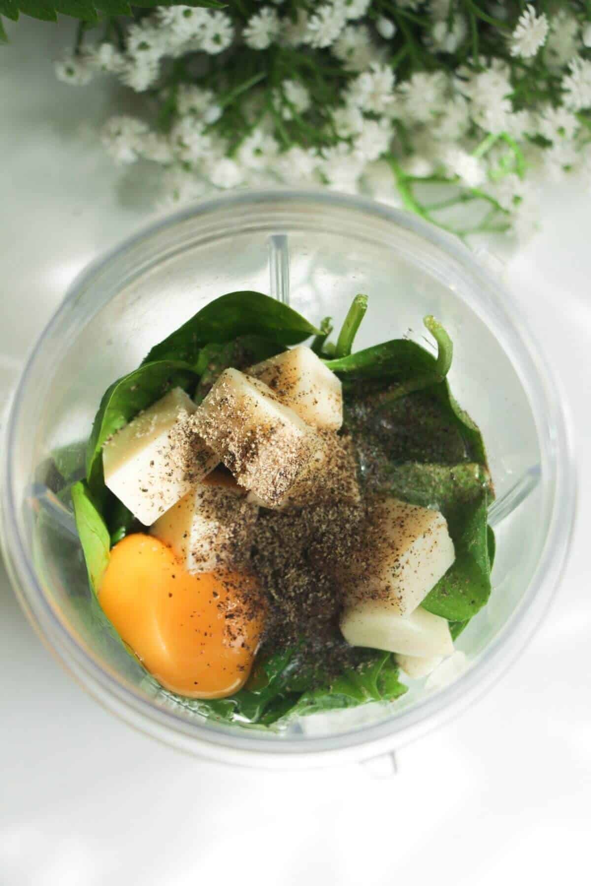 Eggs, parmesan, spinach and basil in a blender.