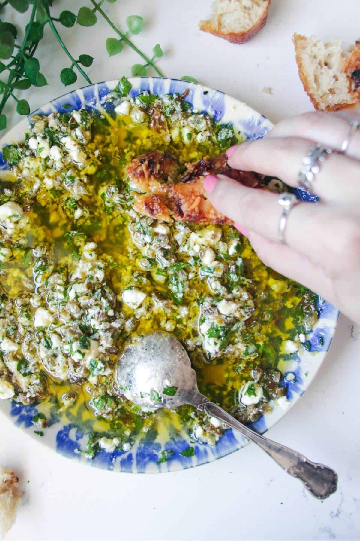 Jalapeno popper bread dipping oil on a blue and white patterned plate.