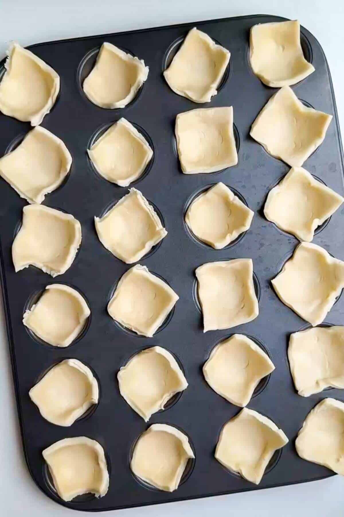 Puff pastry in a mini muffin pan.