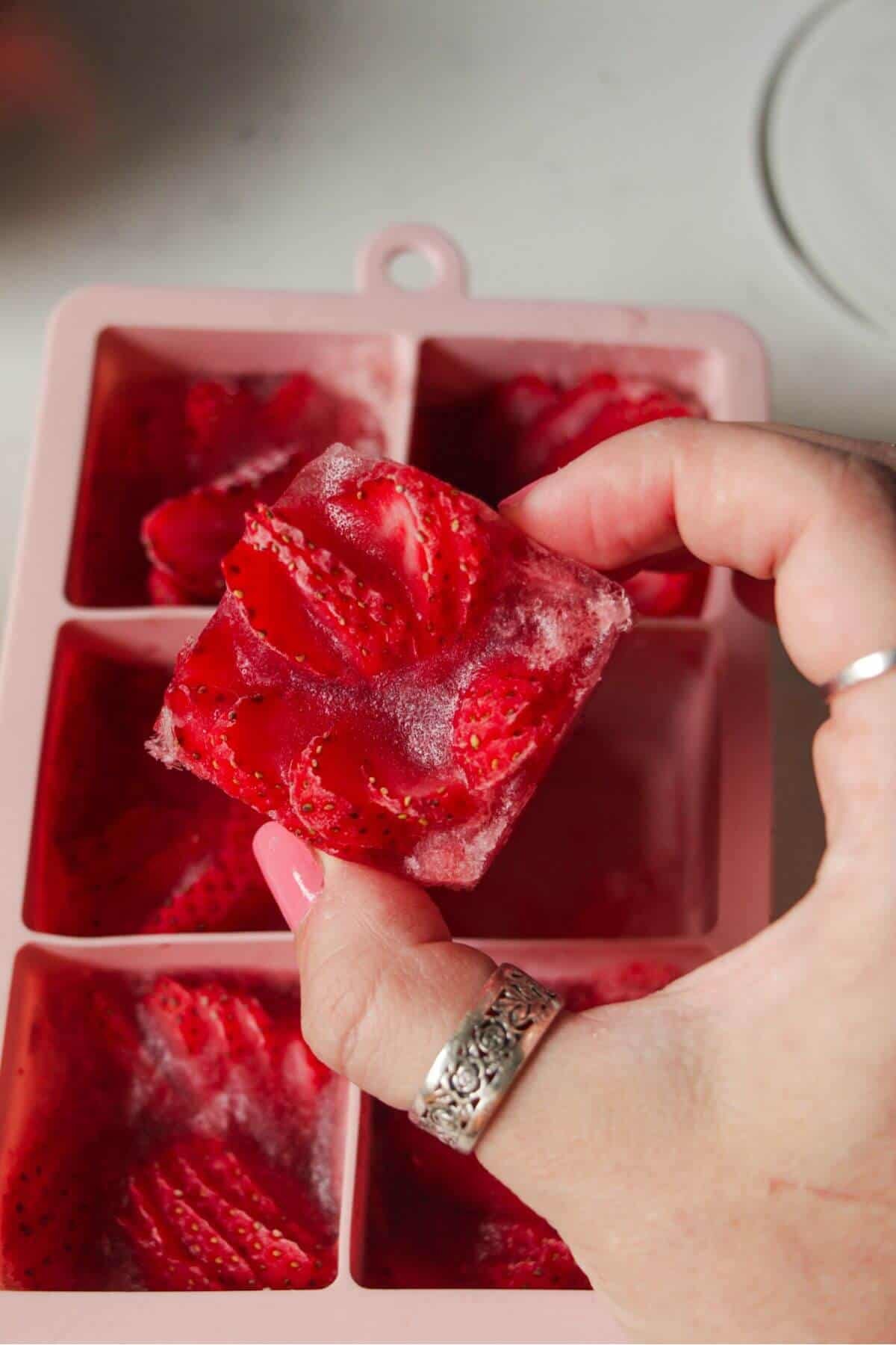 Holding strawberry rose ice cube.