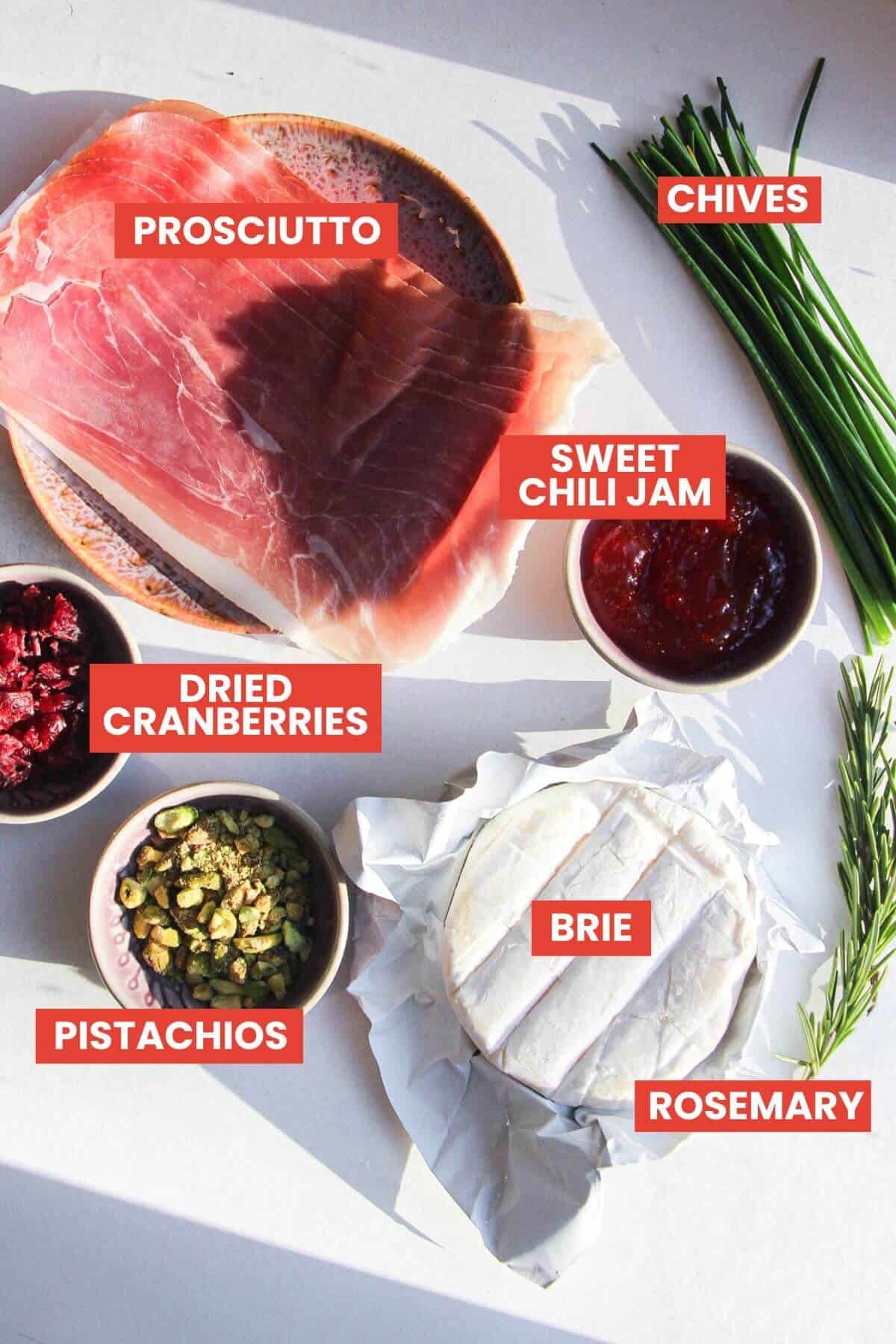 Ingredients for brie stuffed prosciutto bites laid out and labelled.