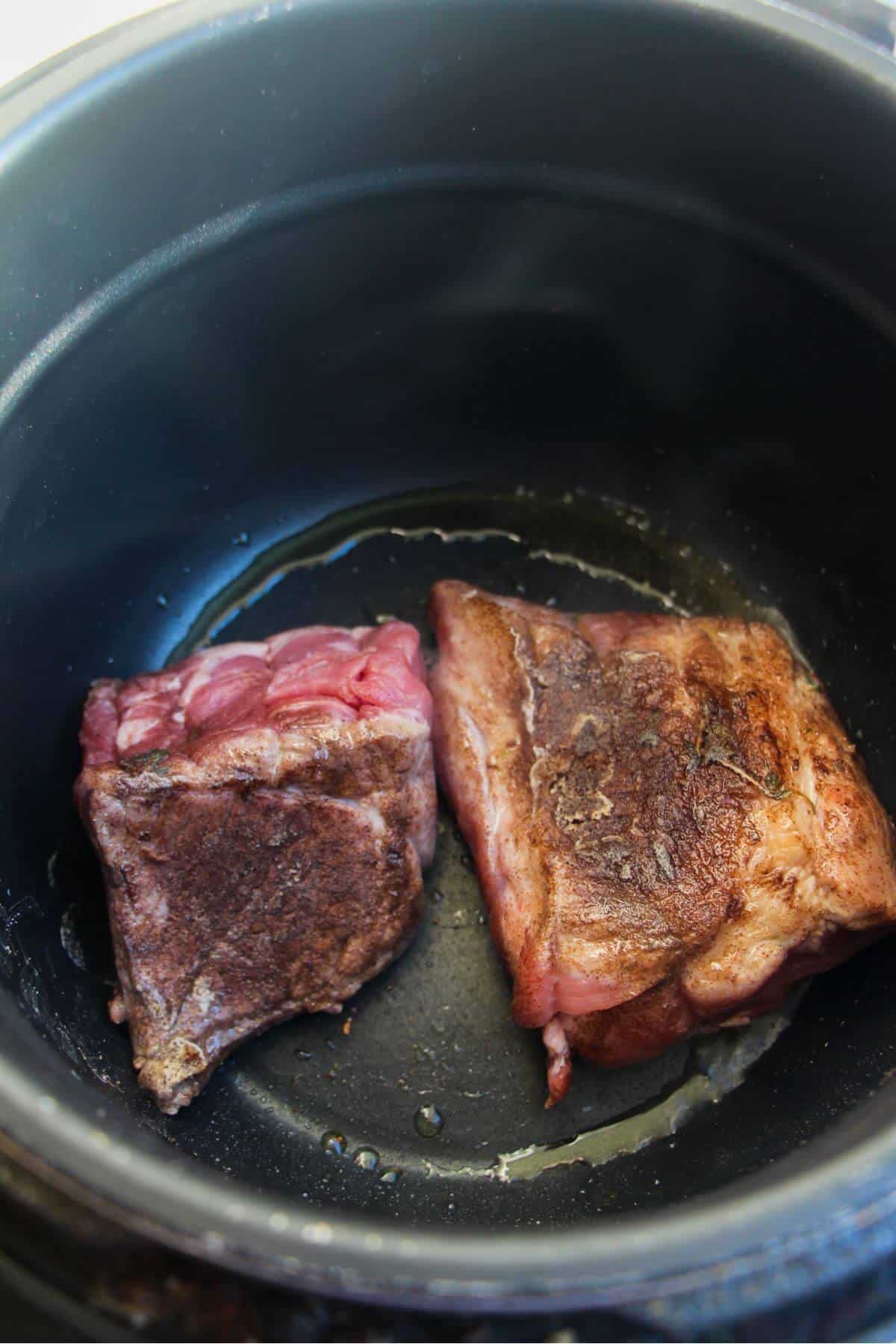 2 pieces of pork shoulder browned in an Instant Pot.