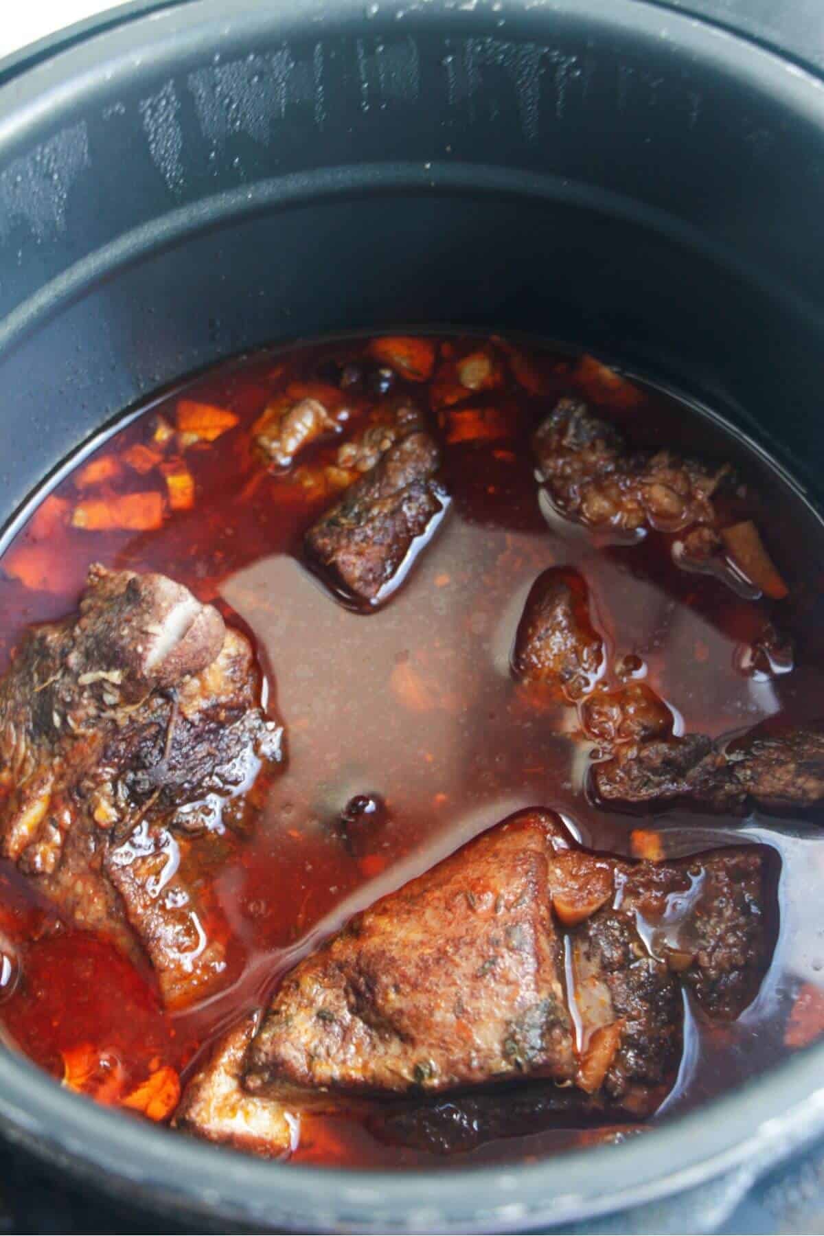 Pork pieces after cooking in the bowl of an Insant Pot.
