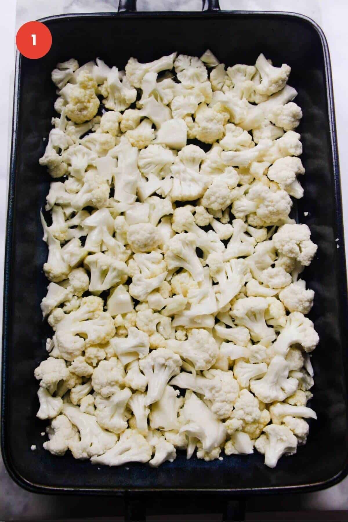 Cauliflower florets laid out in a baking dish.