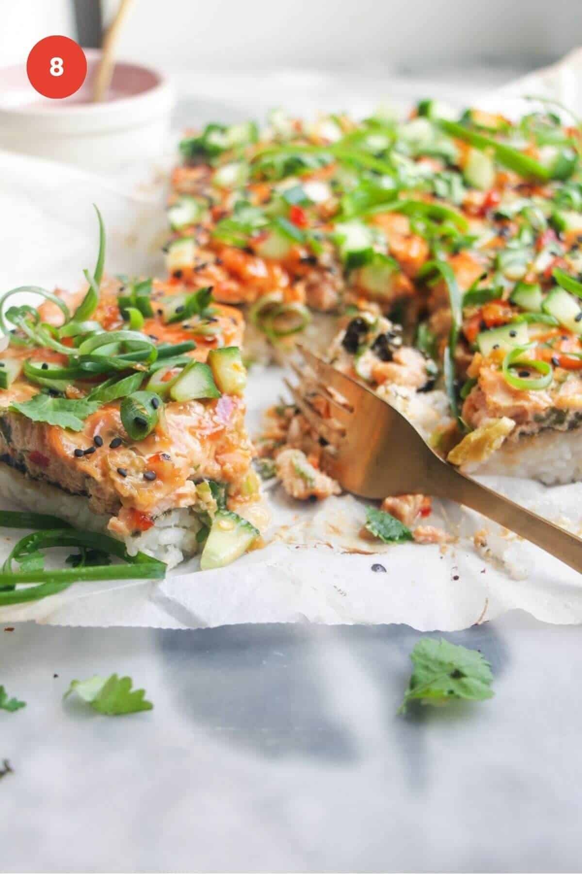 Salmon sushi bake sliced with a fork.