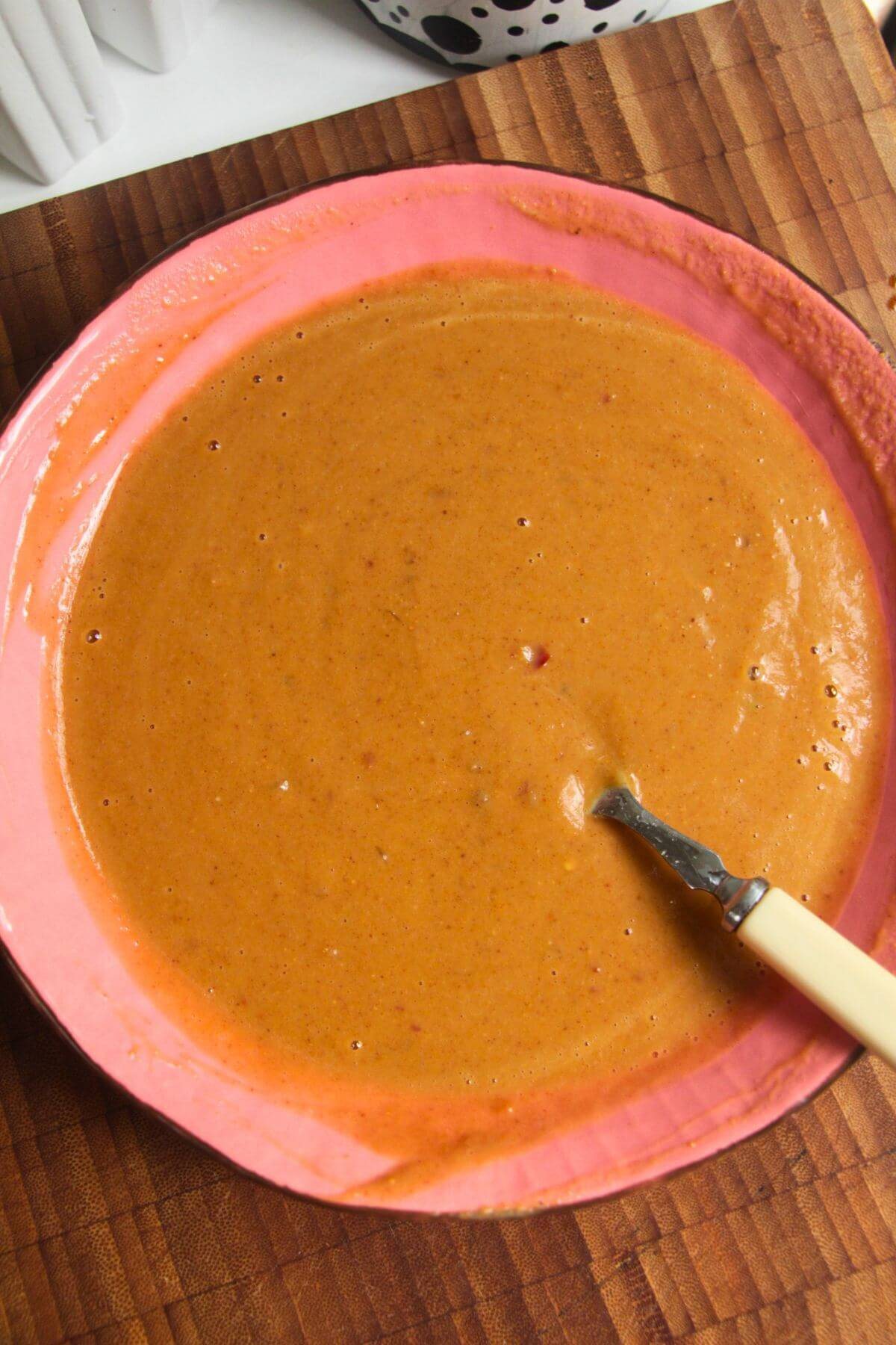 Satay sauce mixed in a pink bowl.