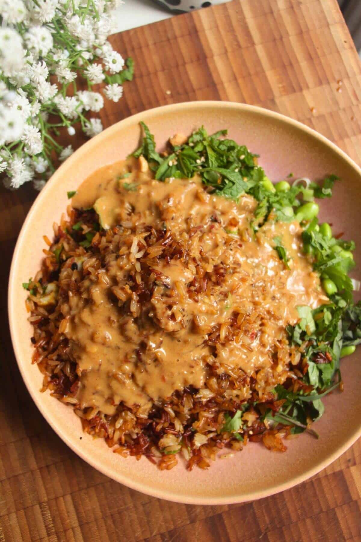 Satay sauce drizzled over crispy rice salad.