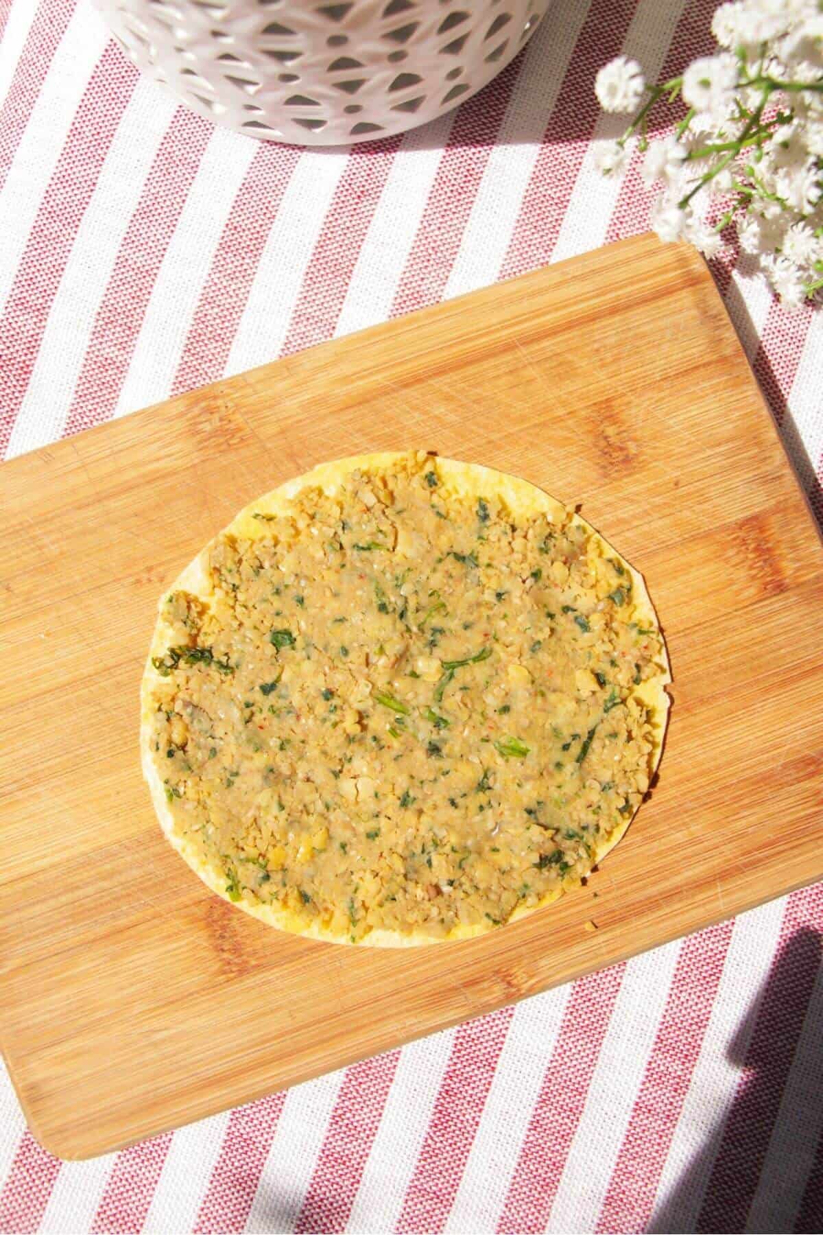Falafel mixture spread onto taco.