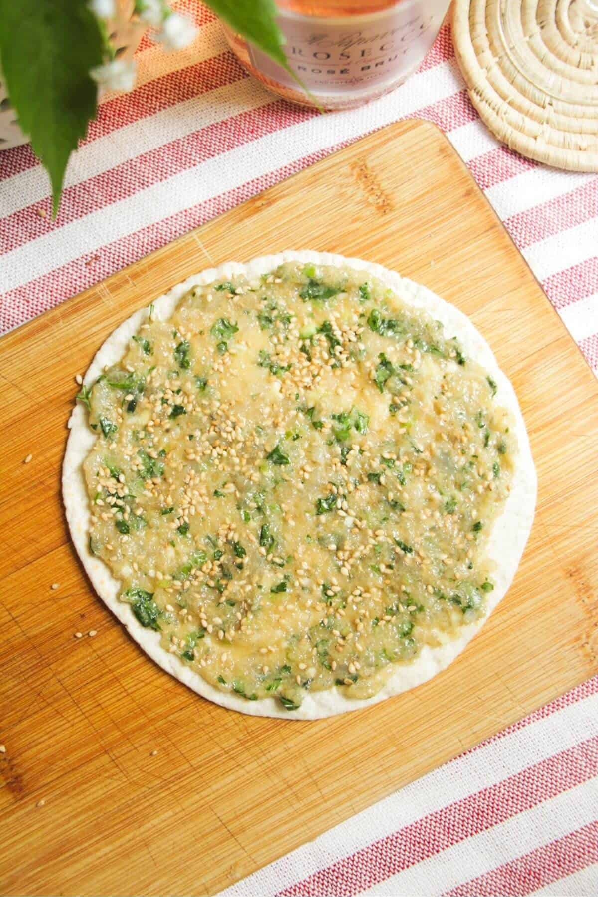 Prawn mixture spread onto mini tortilla.