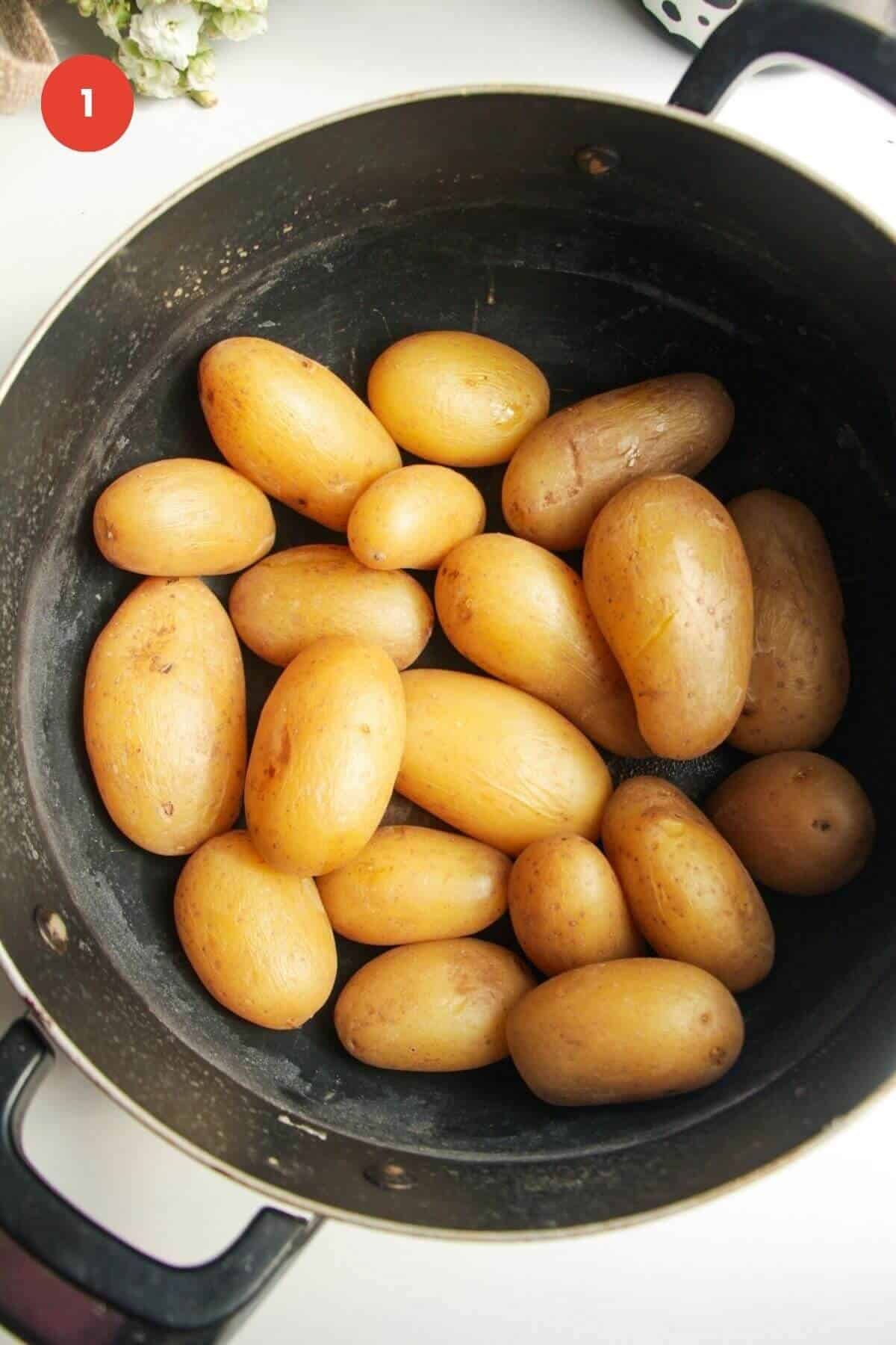 Cooked baby potatoes in a large pot.