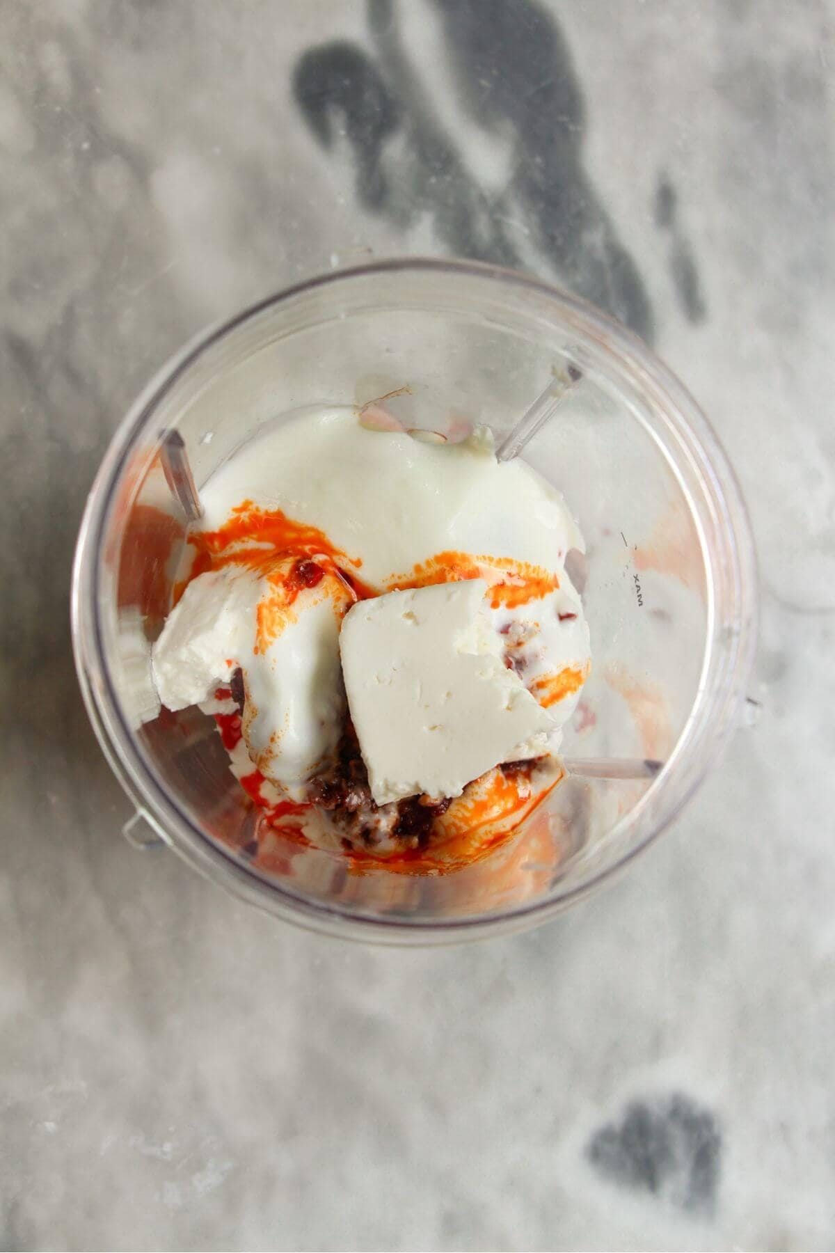 Ingredients for spicy feta dip in a blender.