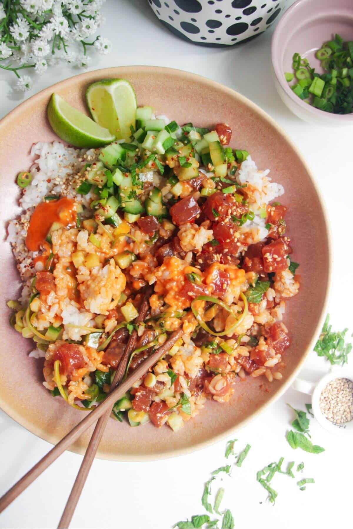 Tuna poke bowl with chopsticks on the side.