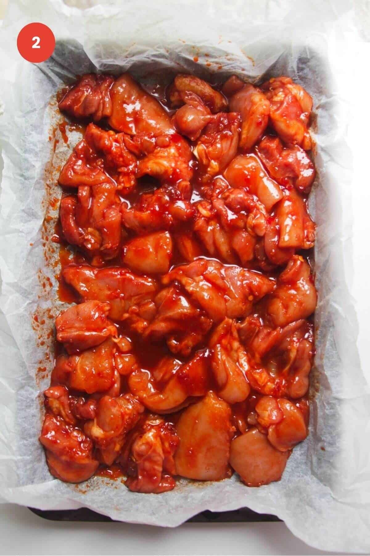 Gochujang marinated chicken arranged in oven tray.