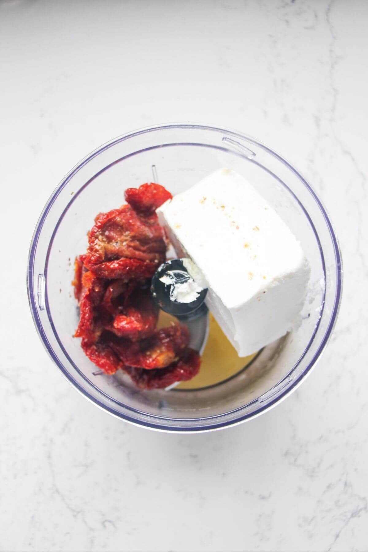 Sundried tomatoes, feta and oil in a small food chopper.