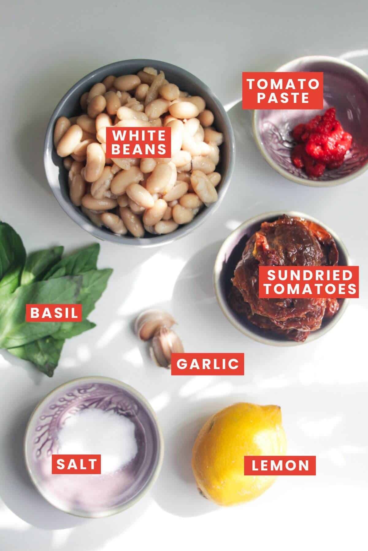 Ingredients for sundried tomato basil hummus laid out and labelled.