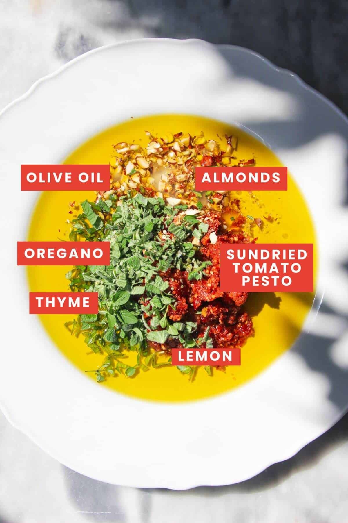 Ingredients for sundried tomato dipping oil on a plate and labelled.