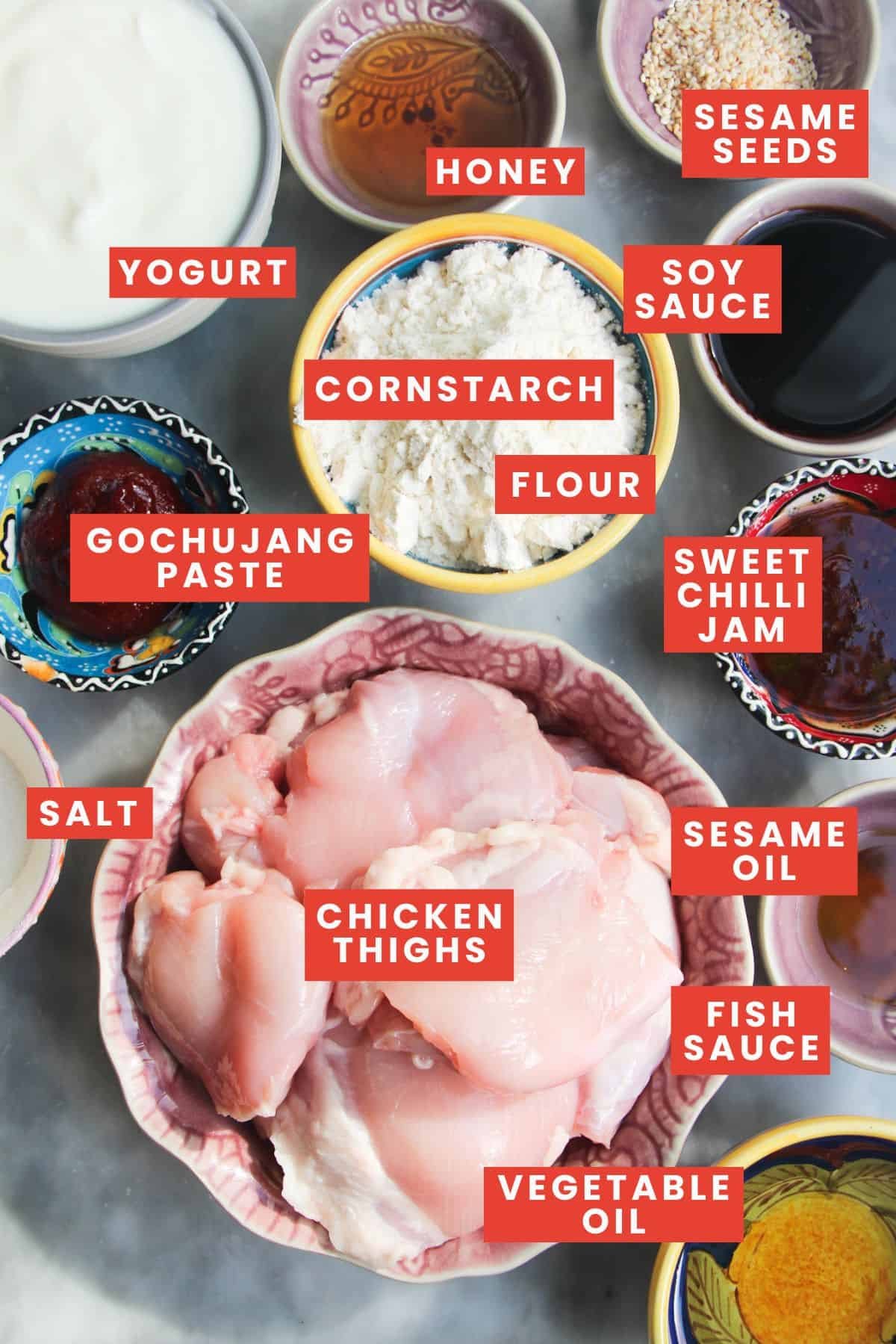 Ingredients for Korean fried chicken, labelled and laid out on a marble background.