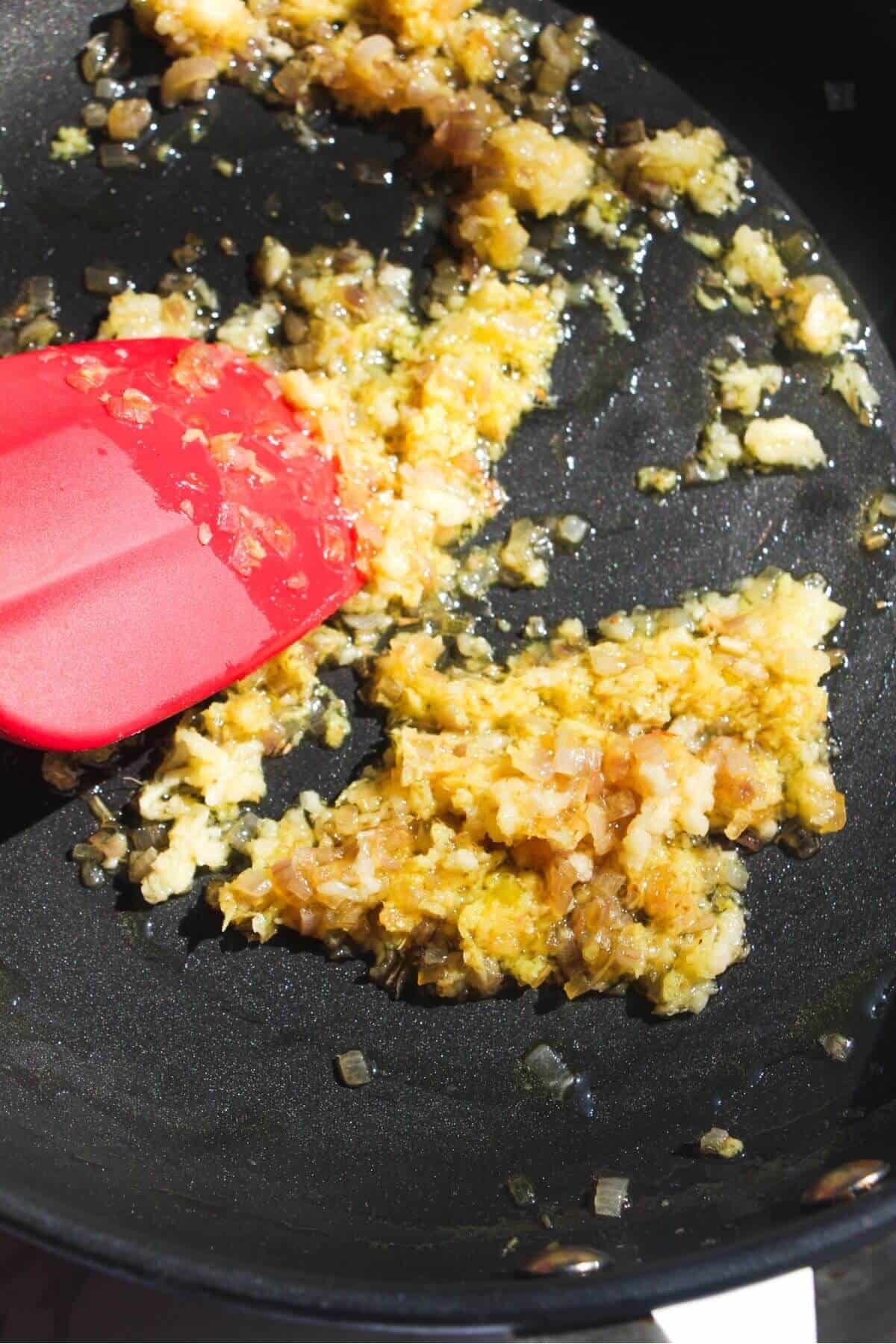 Diced onion, ginger and garlic in a small frying pan.