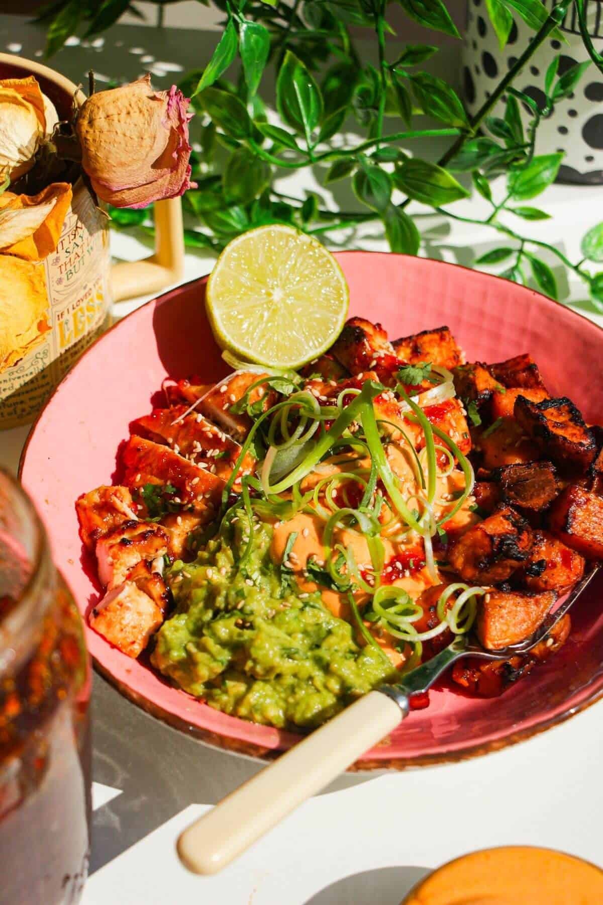 Chicken, sweet potato, whipped cottage cheese and avocado in a pink bowl.