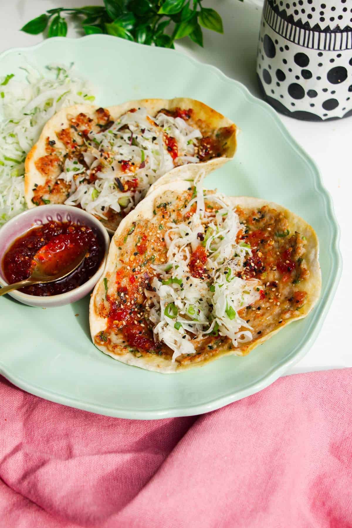 Two sweet chili chicken tacos on serving platter.