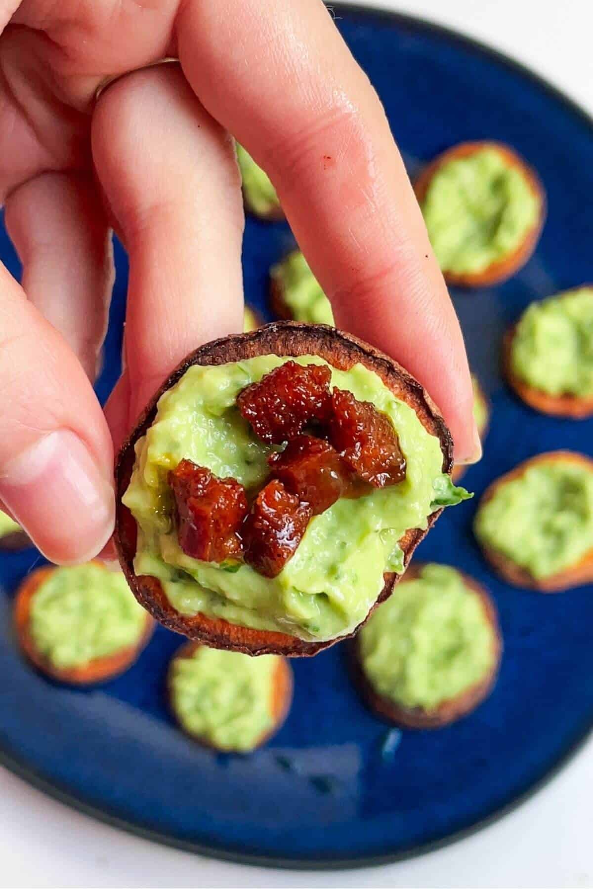 Chorizo on top of avocado on sweet potato bite.