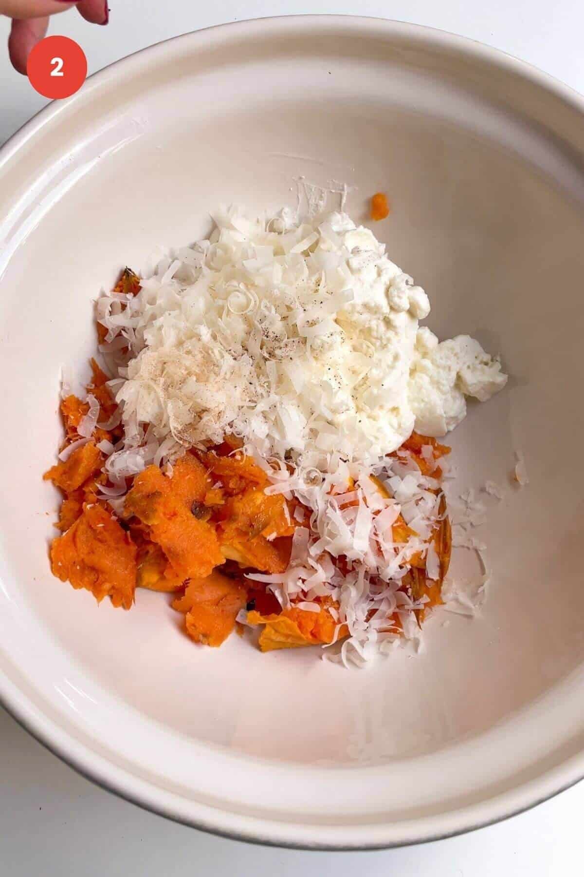 Sweet potato flesh, ricotta, parmesan in a mixing bowl.
