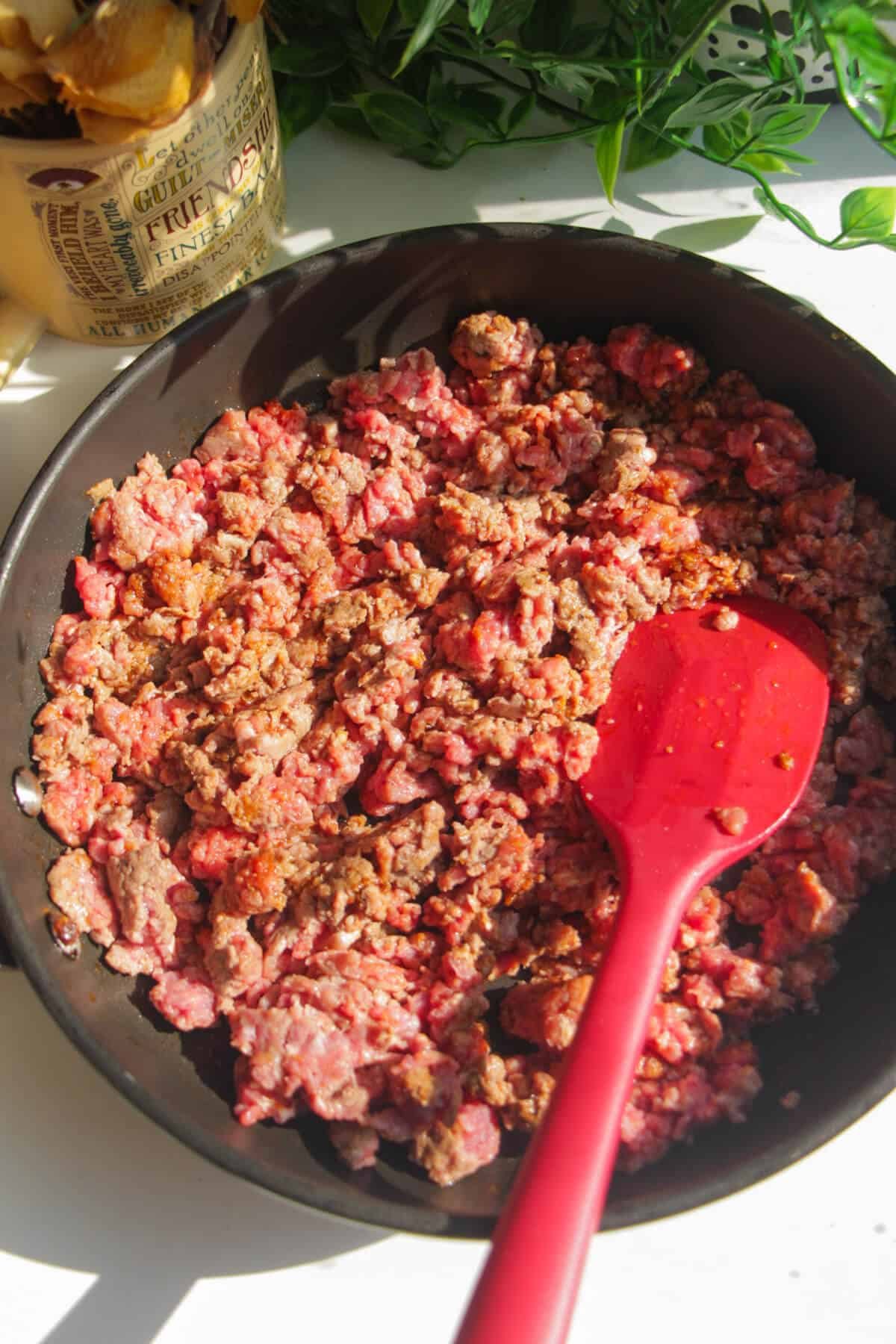 Ground beef added to a pan.