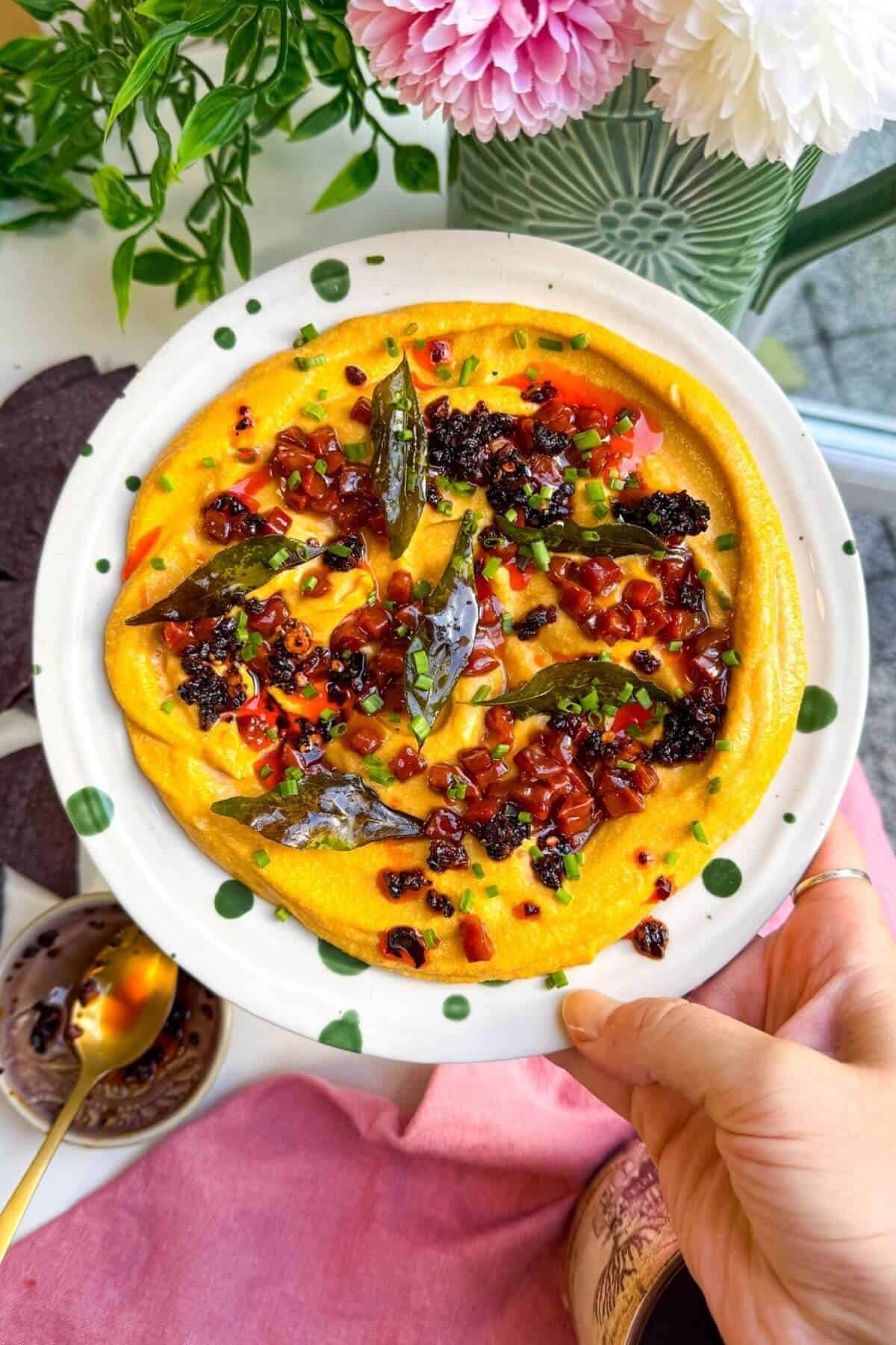 Butternut squash feta dip topped with chorizo, chili crisp and curry leaves.