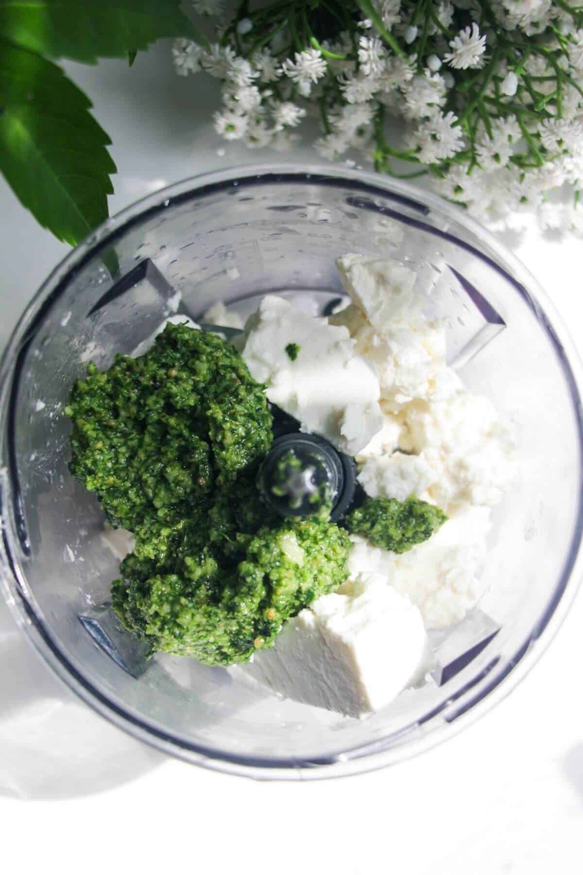 Pesto and feta in a small food chopper.