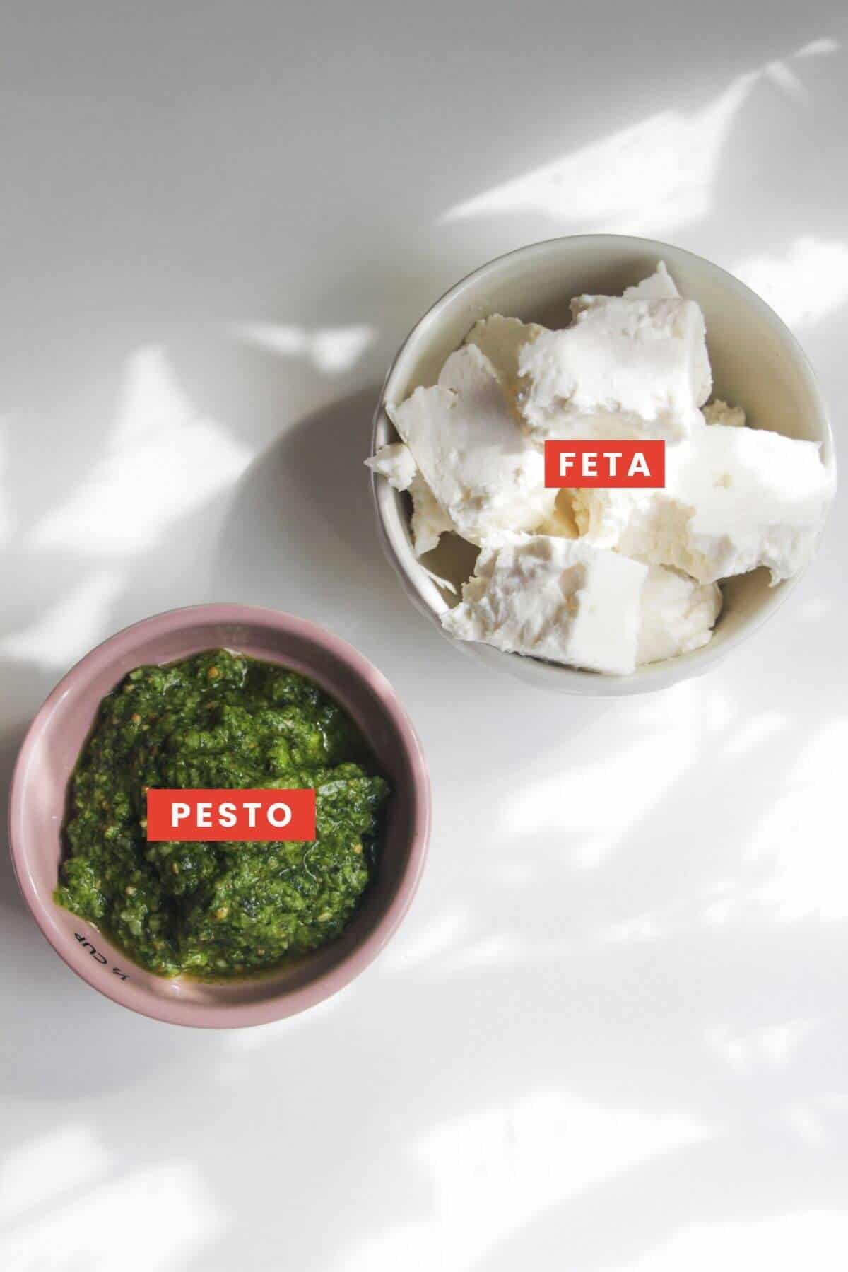 Ingredients for pesto feta dip laid out labelled.