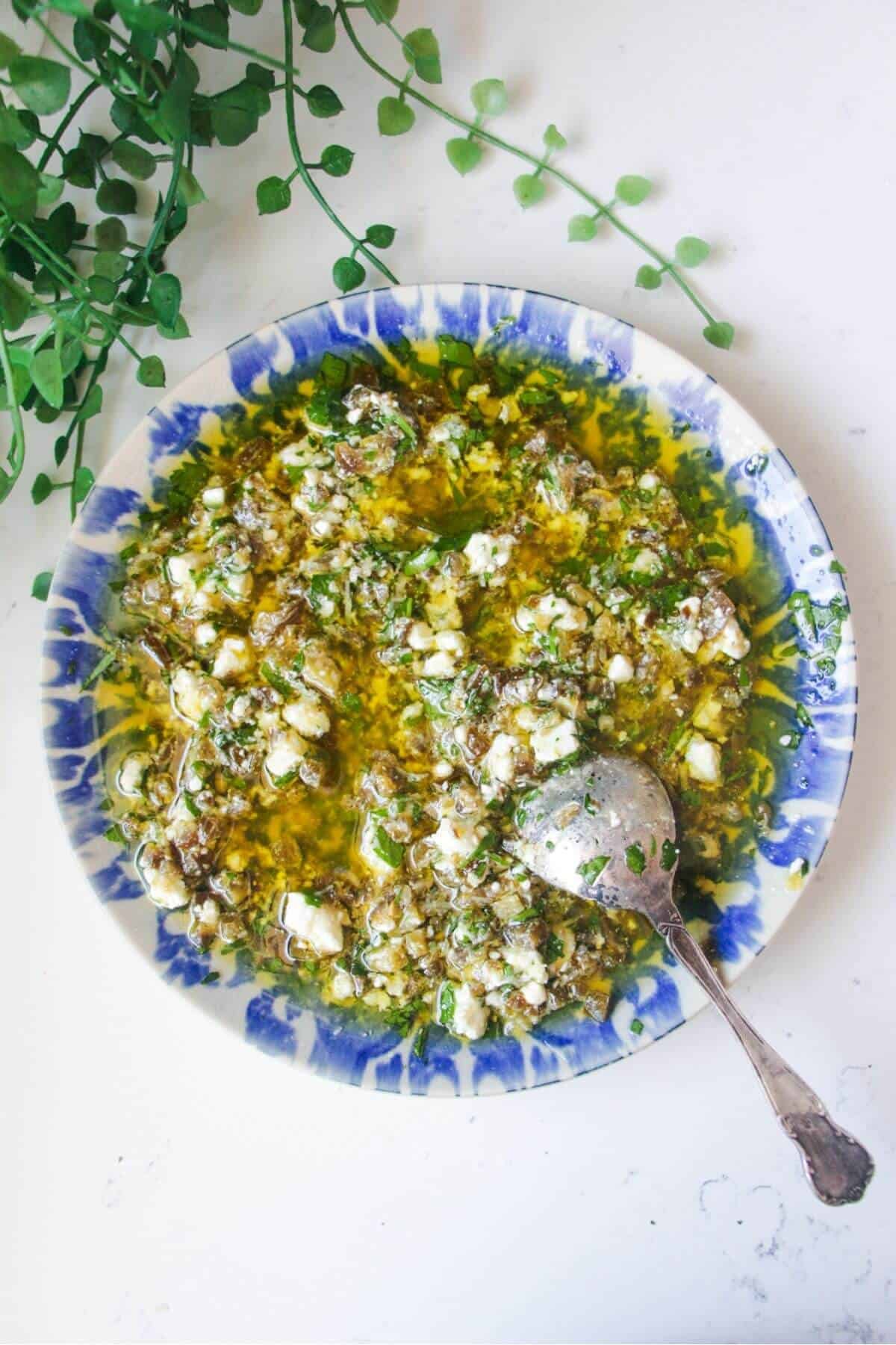Jalapeno popper bread dipping oil on a blue and white patterned plate.