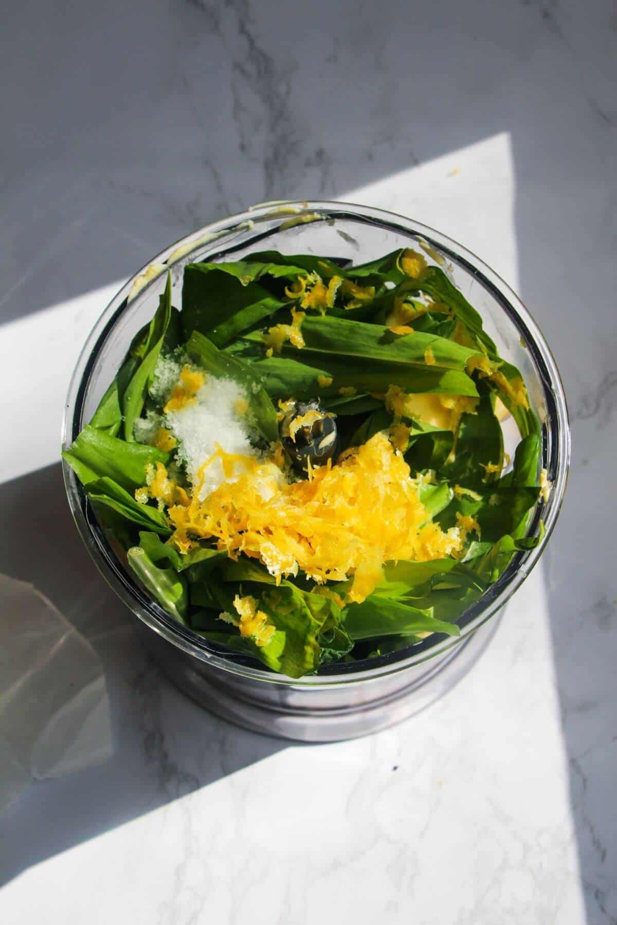 Ingredients for wild garlic butter in a small food processor.