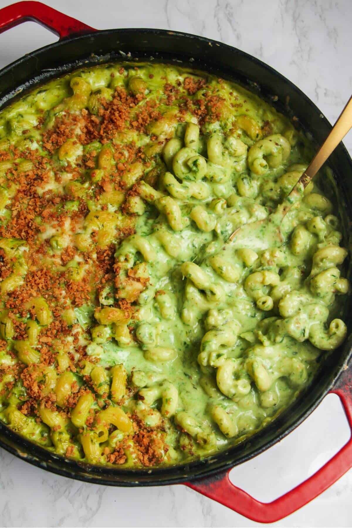 Gold spoon inside gooey green wild garlic mac and cheese.