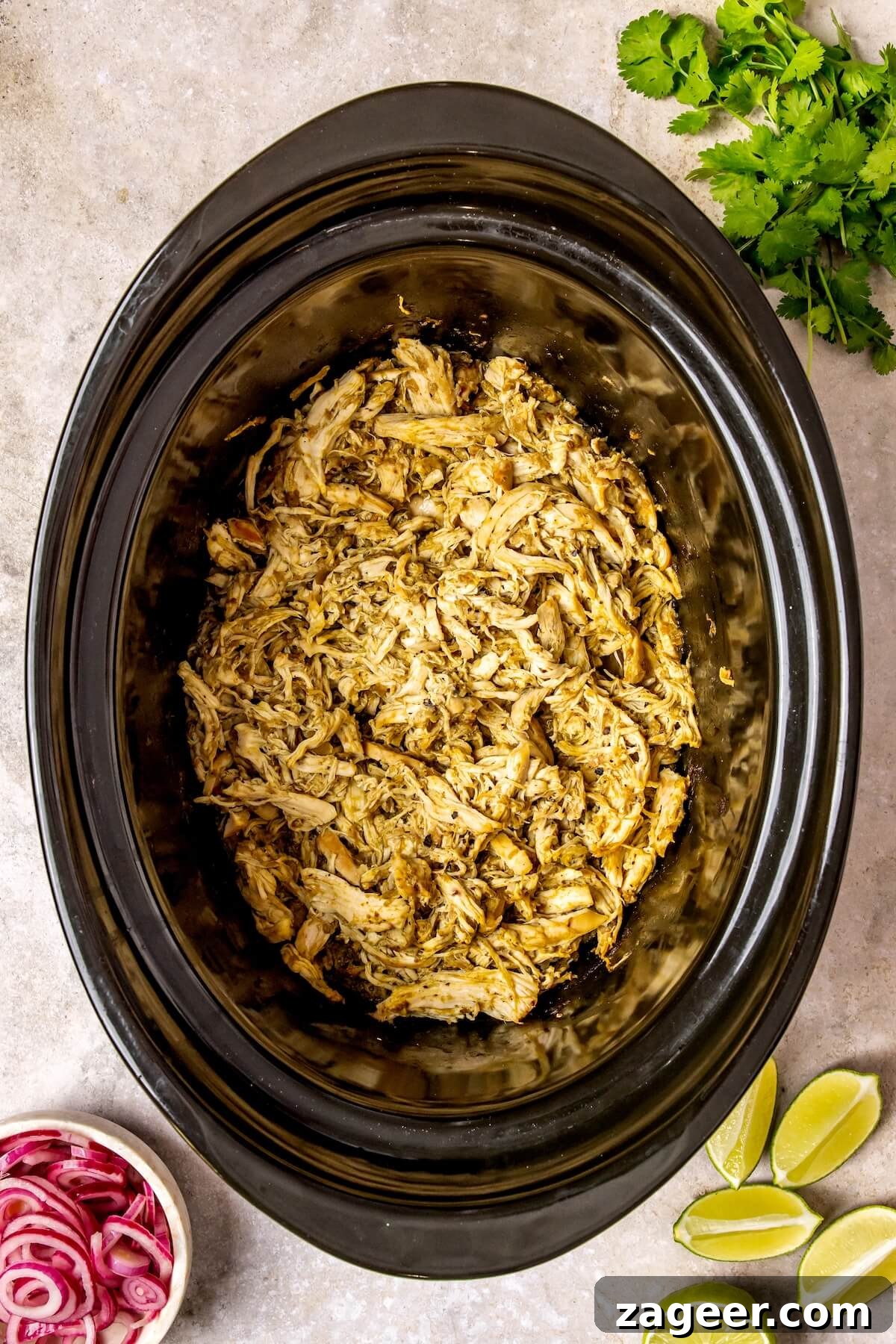 Zesty Slow Cooker Salsa Verde Chicken Tacos 9 Shredded salsa verde chicken in slow cooker