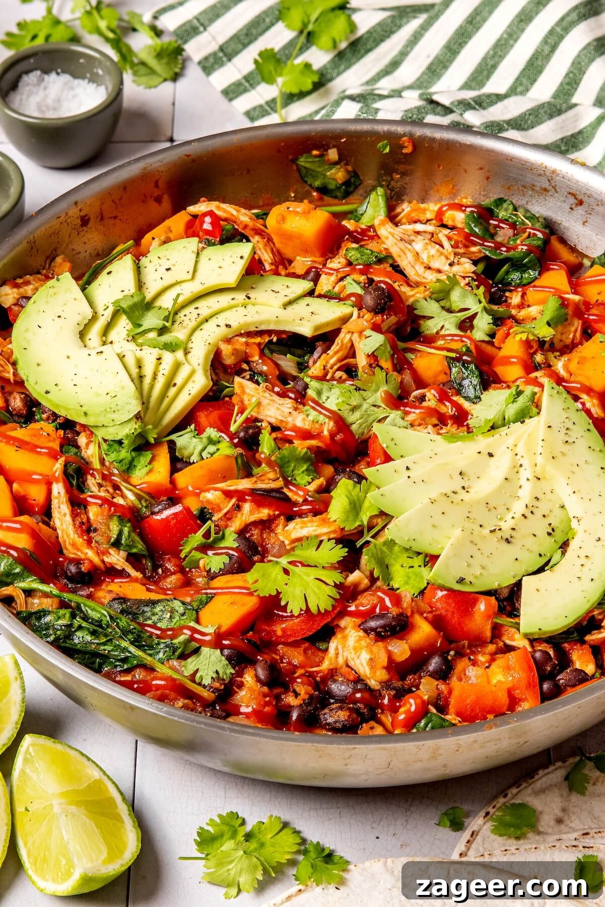 Fiesta Chicken Enchilada Skillet 7 Sweet potatoes and bell peppers cooking in the skillet