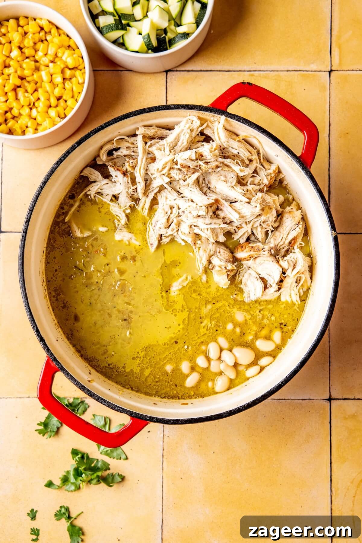 Vibrant Chicken Chili Verde 10 Shredding cooked chicken with two forks.