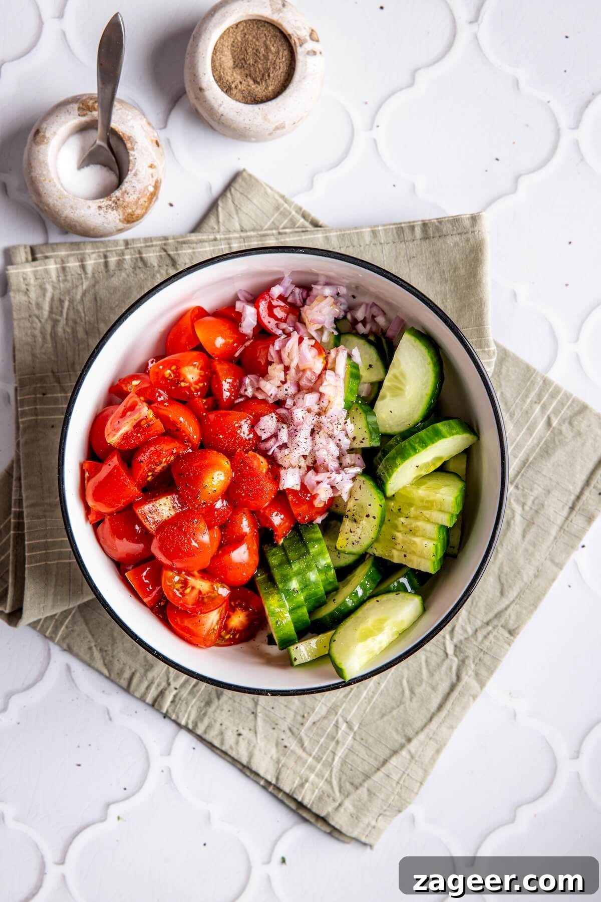Ultimate Greek Chicken Bowl with Zesty Dairy-Free Tzatziki 11 Step 4: Freshly chopped cucumber, tomatoes, and red onion mixed for the Greek salad.